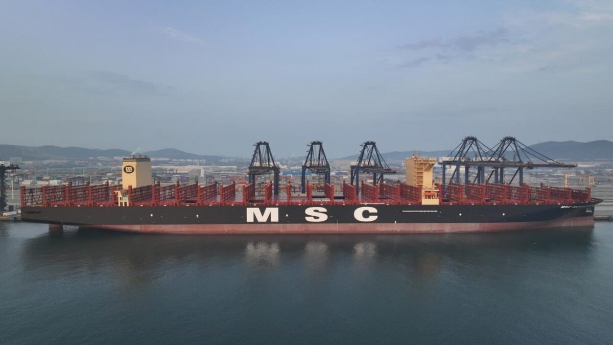 A large, modern Pure Car and Truck Carrier (PCTC) ship at sea.