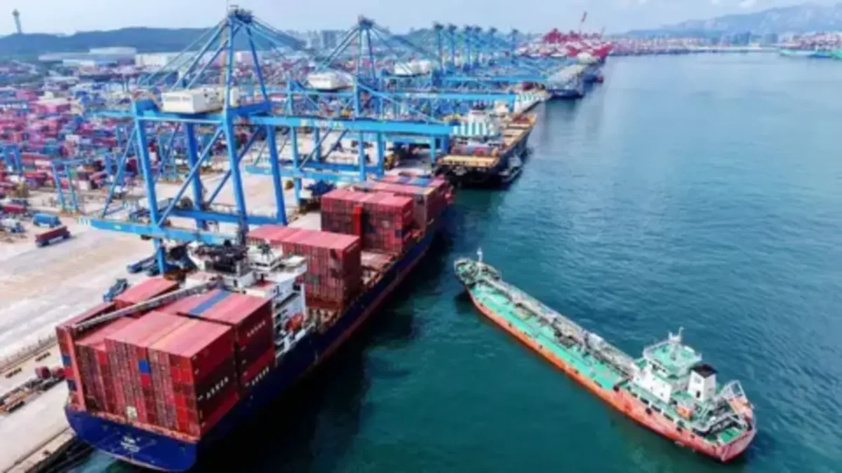 A large container ship with colorful cargo containers at a port, symbolizing international trade.