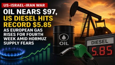 A red semi-truck fills up with diesel at a gas station, reflecting rising fuel costs for shipping.
