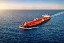 A massive oil supertanker sails on the ocean, central to the global shipping market.