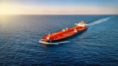 A massive oil supertanker sails on the ocean, central to the global shipping market.