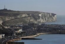 Masked anti-immigration protesters block road at Port of Dover.