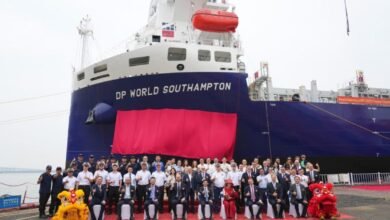 The new DP World London methanol dual-fuel feeder ship docked at a port.