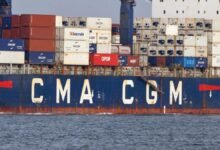 The CMA CGM Symi container ship sails on open water.