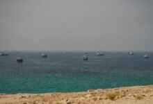 A large commodity tanker transits a waterway, illustrating shipping in the Strait of Hormuz.