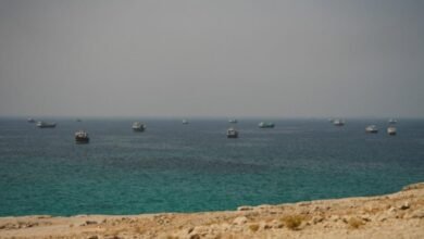 A large commodity tanker transits a waterway, illustrating shipping in the Strait of Hormuz.