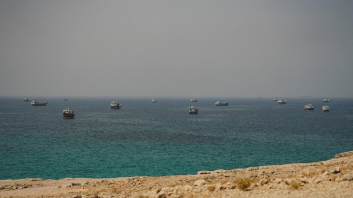 A large commodity tanker transits a waterway, illustrating shipping in the Strait of Hormuz.