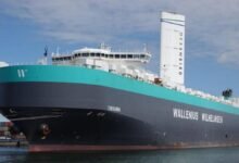 Wallenius Wilhelmsen car carrier with tall white Oceanbird wind sails at sea.