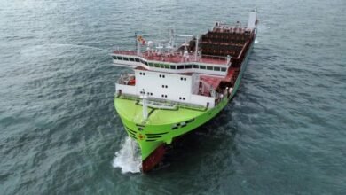 An X-Press Feeders container ship navigates a waterway.