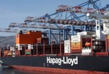A large container ship loaded with cargo, representing global container shipping.