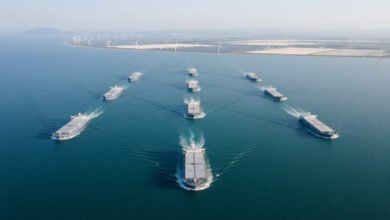 A large cargo ship at a busy port, emblematic of maritime trade and green fuel initiatives.