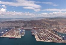 Container ships and cranes at COSCO-managed Piraeus Port container terminal.
