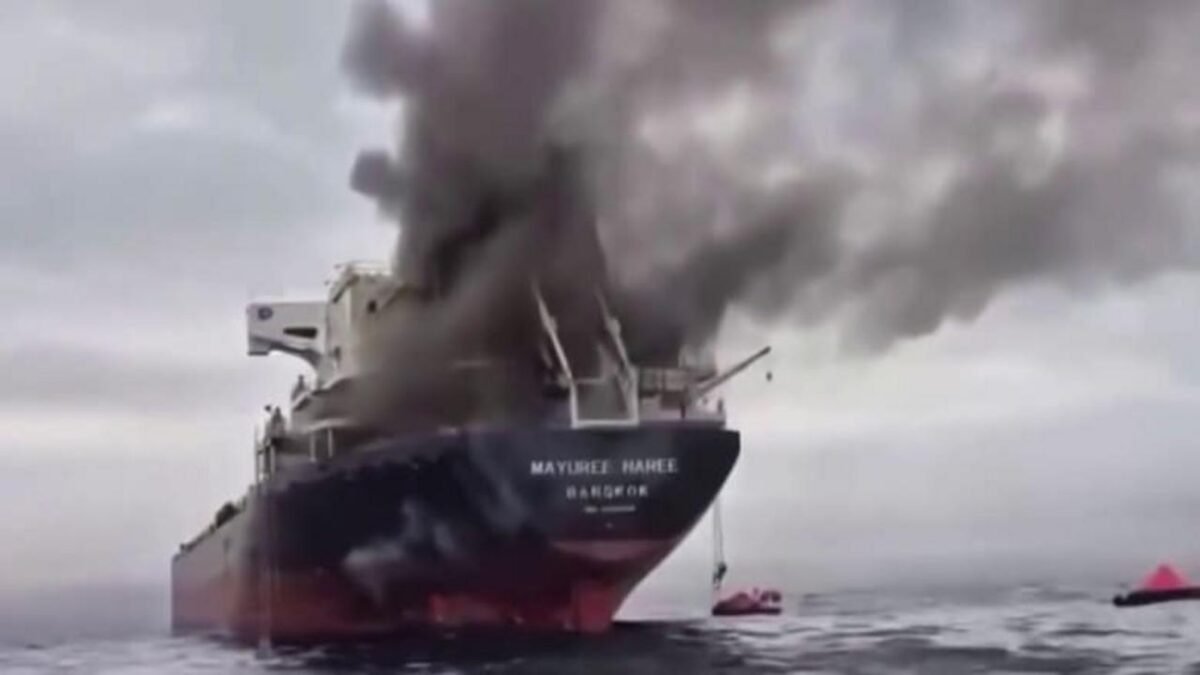 A ship on fire emits thick smoke after an attack in the critical Strait of Hormuz.