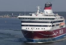 The red and white Viking XPRS passenger ferry sails on water under a clear sky.
