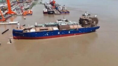 Avenir LNG's newbuild LNG bunkering vessel, white and red, is launched into the water.