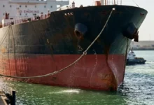 A large CMB.TECH tanker ship sails on the water.