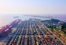 A large container ship sails at sea, symbolizing the Shanghai-Melbourne Green Shipping Corridor.