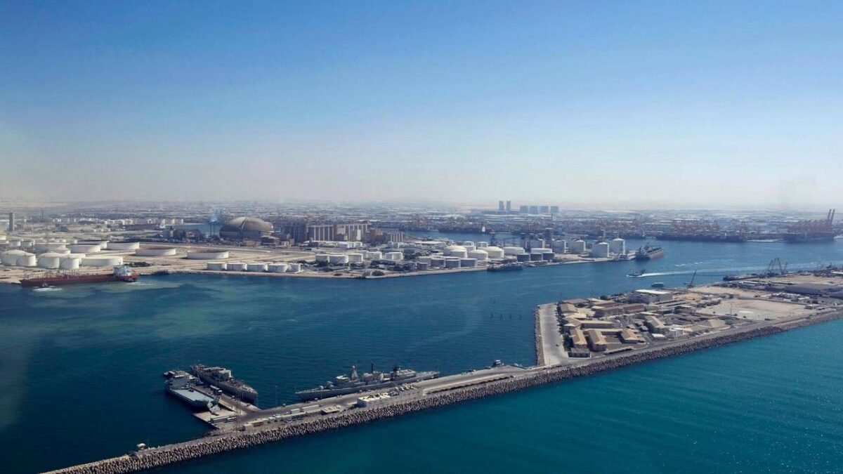 A modern DP World logistics center with shipping containers and trucks.