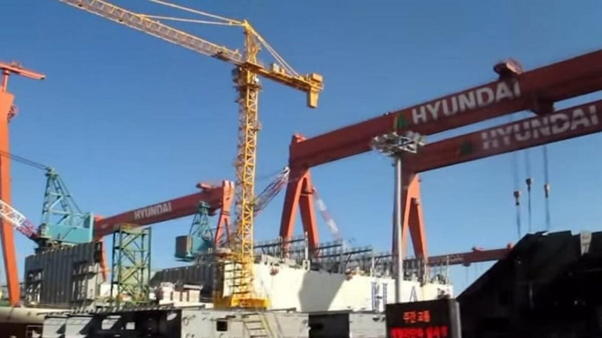HD Hyundai heavy shipbuilding facility with large cranes and industrial infrastructure.