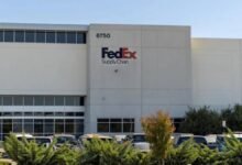 FedEx logistics facility with trucks, representing the company's acquired supply chain operations.