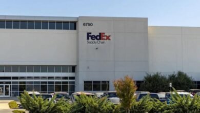 FedEx logistics facility with trucks, representing the company's acquired supply chain operations.