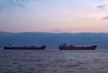 Two supertankers are engaged in a ship-to-ship transfer of crude oil at sea.