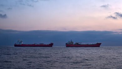 Two supertankers are engaged in a ship-to-ship transfer of crude oil at sea.