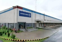 Kuehne+Nagel employees pose inside a modern tech center in India.