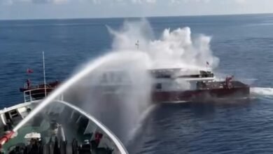 Taiwan Coast Guard vessel fires a water cannon at a Chinese fishing boat.