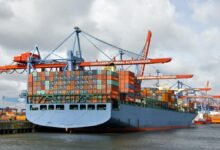 Container ships and cranes at a busy port, reflecting freight volume and capacity.