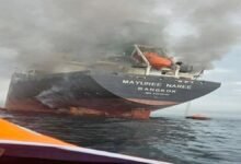 An oil tanker sails through the Strait of Hormuz, a critical maritime shipping route.