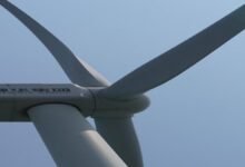 Offshore wind turbines spin, generating power, reflecting China's investment in green energy.