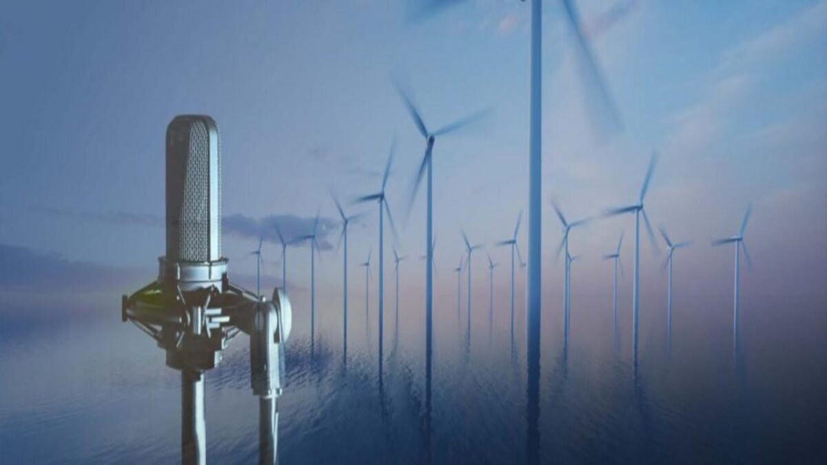 A specialized vessel transports a large floating offshore wind turbine base across the ocean.