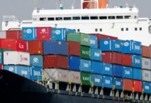 A large Hanjin container ship sails on the open sea.