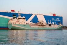 A large car carrier vessel docked in Hong Kong undergoing its first LNG bunkering operation.