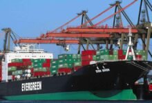 An Evergreen container ship sails through a busy shipping lane.