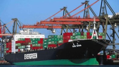 An Evergreen container ship sails through a busy shipping lane.